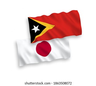 National vector fabric wave flags of Japan and East Timor isolated on white background. 1 to 2 proportion.