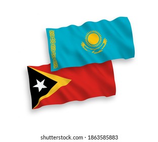 National vector fabric wave flags of Kazakhstan and East Timor isolated on white background. 1 to 2 proportion.