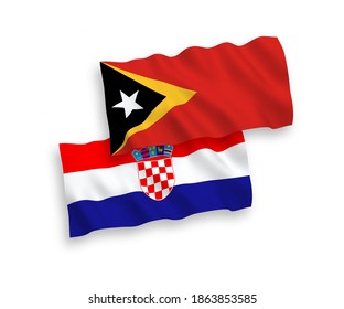 National vector fabric wave flags of East Timor and Croatia isolated on white background. 1 to 2 proportion.