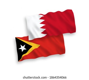 National vector fabric wave flags of East Timor and Bahrain isolated on white background. 1 to 2 proportion.