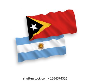 National vector fabric wave flags of East Timor and Argentina isolated on white background. 1 to 2 proportion.