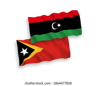 National vector fabric wave flags of East Timor and Libya isolated on white background. 1 to 2 proportion.