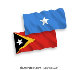 National vector fabric wave flags of East Timor and Somalia isolated on white background. 1 to 2 proportion.