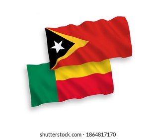 National vector fabric wave flags of East Timor and Benin isolated on white background. 1 to 2 proportion.
