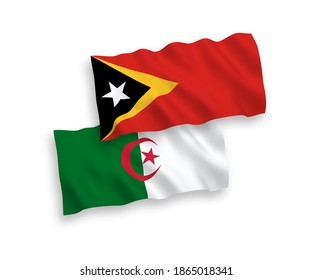 National vector fabric wave flags of East Timor and Algeria isolated on white background. 1 to 2 proportion.