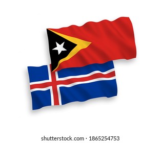National vector fabric wave flags of East Timor and Iceland isolated on white background. 1 to 2 proportion.