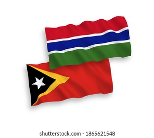 National vector fabric wave flags of East Timor and Republic of Gambia isolated on white background. 1 to 2 proportion.