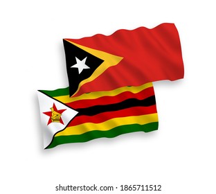 National vector fabric wave flags of East Timor and Zimbabwe isolated on white background. 1 to 2 proportion.