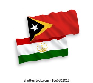 National vector fabric wave flags of East Timor and Tajikistan isolated on white background. 1 to 2 proportion.