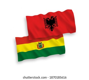 National vector fabric wave flags of Bolivia and Albania isolated on white background. 1 to 2 proportion.