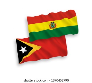 National vector fabric wave flags of Bolivia and East Timor isolated on white background. 1 to 2 proportion.