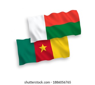 National vector fabric wave flags of Cameroon and Madagascar isolated on white background. 1 to 2 proportion.