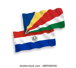 National vector fabric wave flags of Paraguay and Seychelles isolated on white background. 1 to 2 proportion.