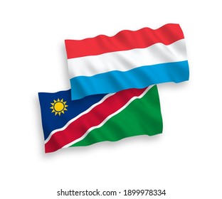 National vector fabric wave flags of Republic of Namibia and Luxembourg isolated on white background. 1 to 2 proportion.