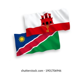 National vector fabric wave flags of Republic of Namibia and Gibraltar isolated on white background. 1 to 2 proportion.