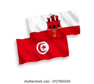 National vector fabric wave flags of Republic of Tunisia and Gibraltar isolated on white background. 1 to 2 proportion.