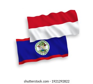 National vector fabric wave flags of Indonesia and Belize isolated on white background. 1 to 2 proportion.
