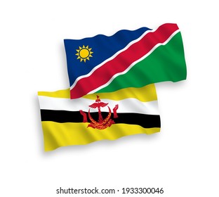 National vector fabric wave flags of Brunei and Republic of Namibia isolated on white background. 1 to 2 proportion.