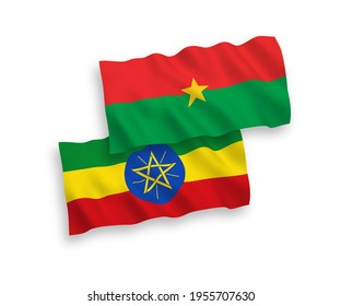 National vector fabric wave flags of Burkina Faso and Ethiopia isolated on white background. 1 to 2 proportion.