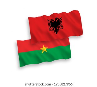 National vector fabric wave flags of Burkina Faso and Albania isolated on white background. 1 to 2 proportion.