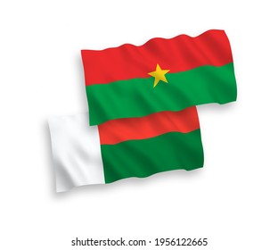 National vector fabric wave flags of Burkina Faso and Madagascar isolated on white background. 1 to 2 proportion.