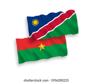 National vector fabric wave flags of Burkina Faso and Republic of Namibia isolated on white background. 1 to 2 proportion.