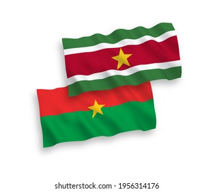 National vector fabric wave flags of Burkina Faso and Republic of Suriname isolated on white background. 1 to 2 proportion.