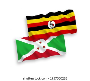 National vector fabric wave flags of Burundi and Uganda isolated on white background. 1 to 2 proportion.