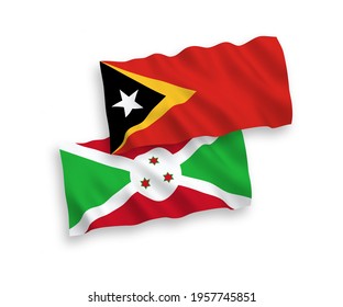 National vector fabric wave flags of Burundi and East Timor isolated on white background. 1 to 2 proportion.