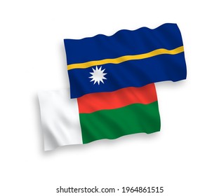 National vector fabric wave flags of Republic of Nauru and Madagascar isolated on white background. 1 to 2 proportion.