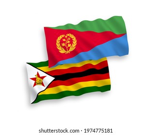 National vector fabric wave flags of Eritrea and Zimbabwe isolated on white background. 1 to 2 proportion.