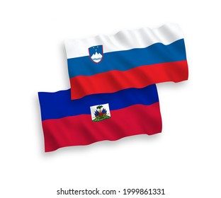 National vector fabric wave flags of Slovenia and Republic of Haiti isolated on white background. 1 to 2 proportion.