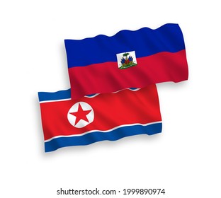 National vector fabric wave flags of North Korea and Republic of Haiti isolated on white background. 1 to 2 proportion.
