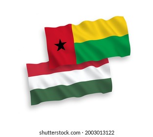 Banderas de olas de tela vectorial nacional de la República de Guinea Bissau y Hungría aisladas en fondo blanco. de 1 a 2.