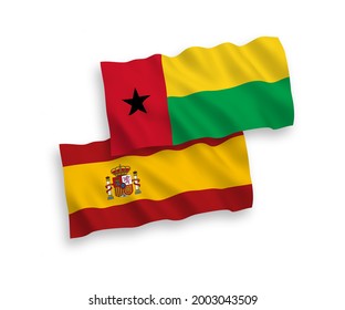 National vector fabric wave flags of Republic of Guinea Bissau and Spain isolated on white background. 1 to 2 proportion.