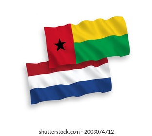 National vector fabric wave flags of Republic of Guinea Bissau and Netherlands isolated on white background. 1 to 2 proportion.