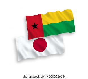 National vector fabric wave flags of Japan and Republic of Guinea Bissau isolated on white background. 1 to 2 proportion.