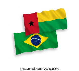 National vector fabric wave flags of Brazil and Republic of Guinea Bissau isolated on white background. 1 to 2 proportion.