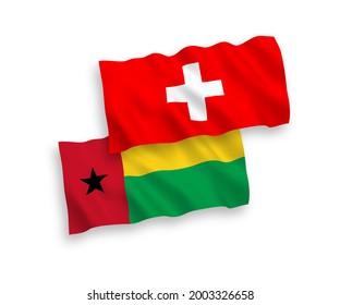 National vector fabric wave flags of Republic of Guinea Bissau and Switzerland isolated on white background. 1 to 2 proportion.