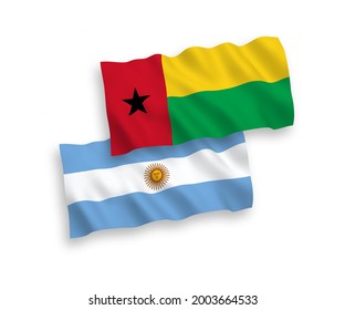 National vector fabric wave flags of Republic of Guinea Bissau and Argentina isolated on white background. 1 to 2 proportion.