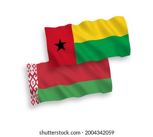 National vector fabric wave flags of Republic of Guinea Bissau and Belarus isolated on white background. 1 to 2 proportion.