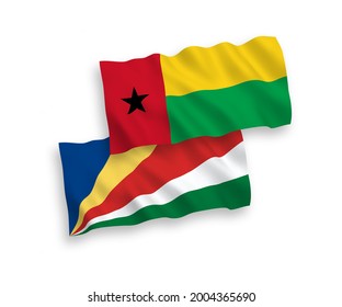 National vector fabric wave flags of Republic of Guinea Bissau and Seychelles isolated on white background. 1 to 2 proportion.