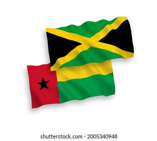 National vector fabric wave flags of Republic of Guinea Bissau and Jamaica isolated on white background. 1 to 2 proportion.
