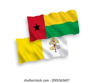 National vector fabric wave flags of Republic of Guinea Bissau and Vatican isolated on white background. 1 to 2 proportion.