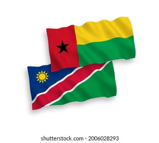 National vector fabric wave flags of Republic of Guinea Bissau and Republic of Namibia isolated on white background. 1 to 2 proportion.