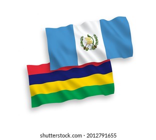 National vector fabric wave flags of Republic of Guatemala and Republic of Mauritius isolated on white background. 1 to 2 proportion.