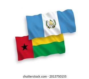 National vector fabric wave flags of Republic of Guatemala and Republic of Guinea Bissau isolated on white background. 1 to 2 proportion.