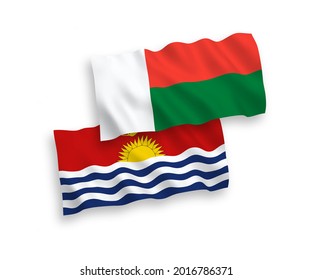 National vector fabric wave flags of Republic of Kiribati and Madagascar isolated on white background. 1 to 2 proportion.
