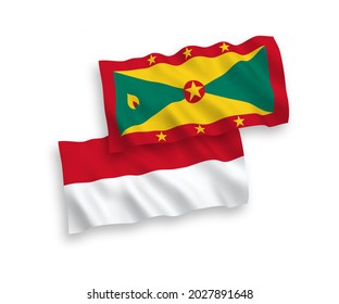 National vector fabric wave flags of Indonesia and Grenada isolated on white background. 1 to 2 proportion.