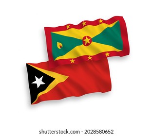National vector fabric wave flags of Grenada and East Timor isolated on white background. 1 to 2 proportion.